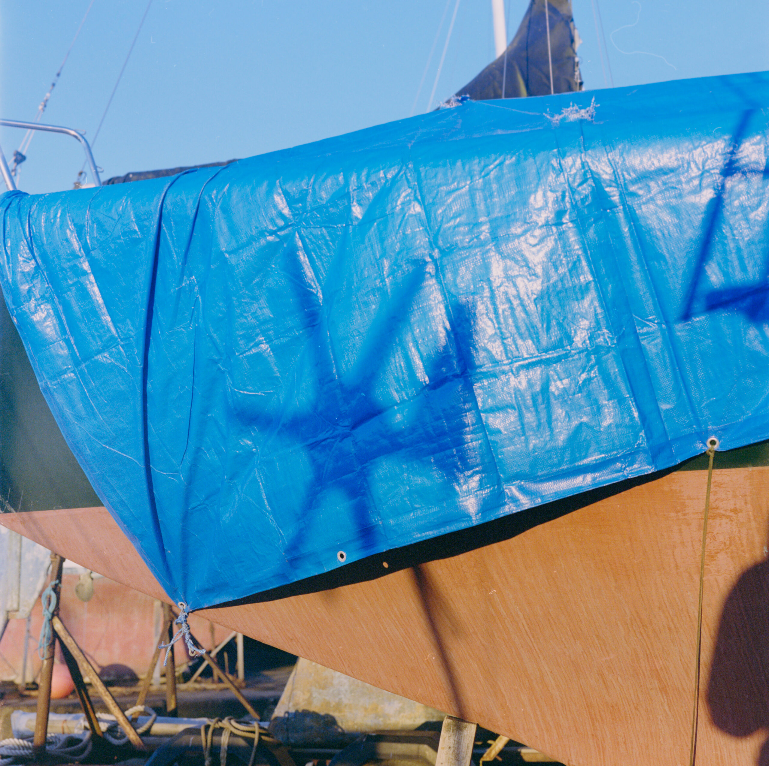 Bright blue weathered boat cover and rigging