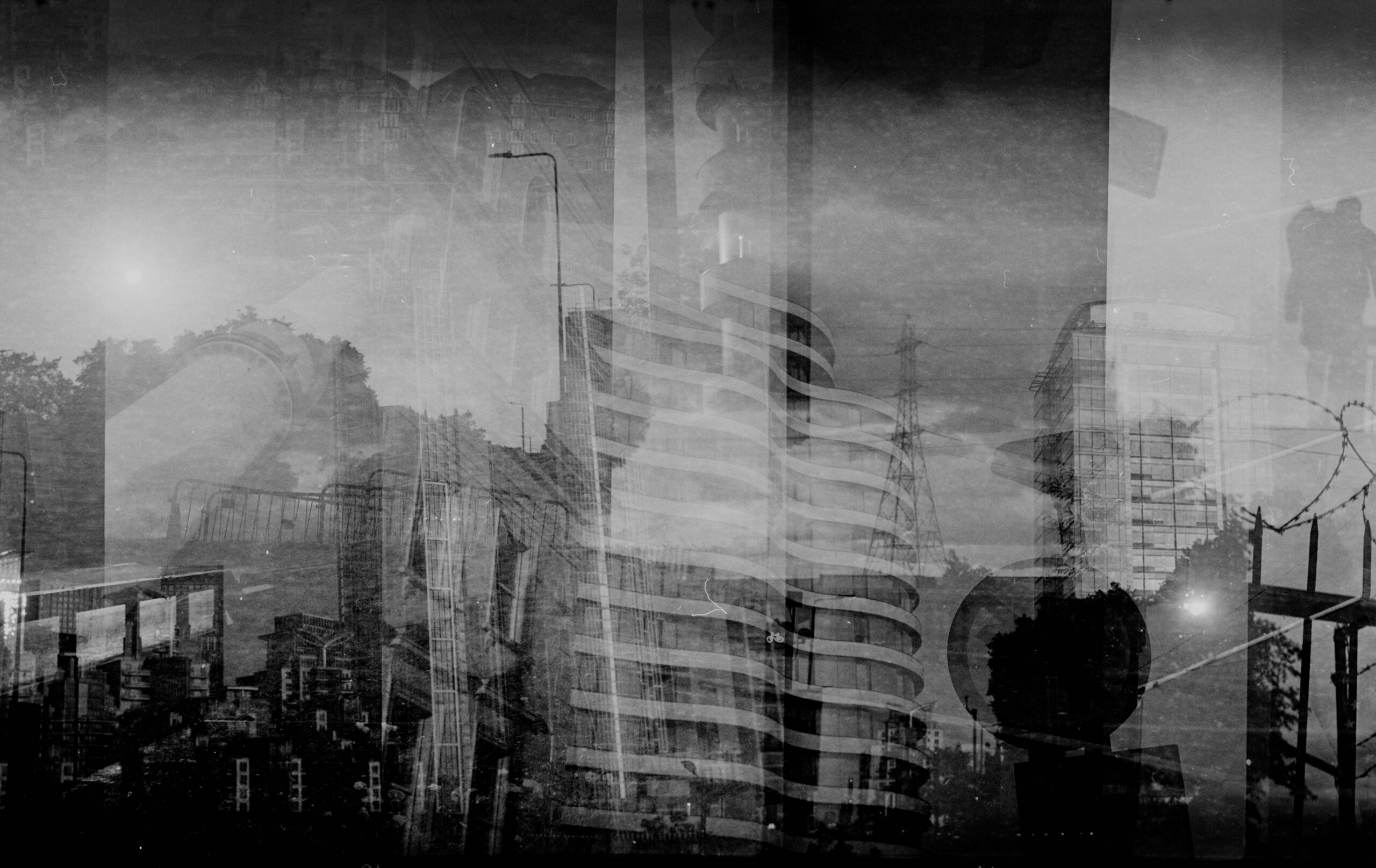 Moody black-and-white layered cityscape with buildings and trees