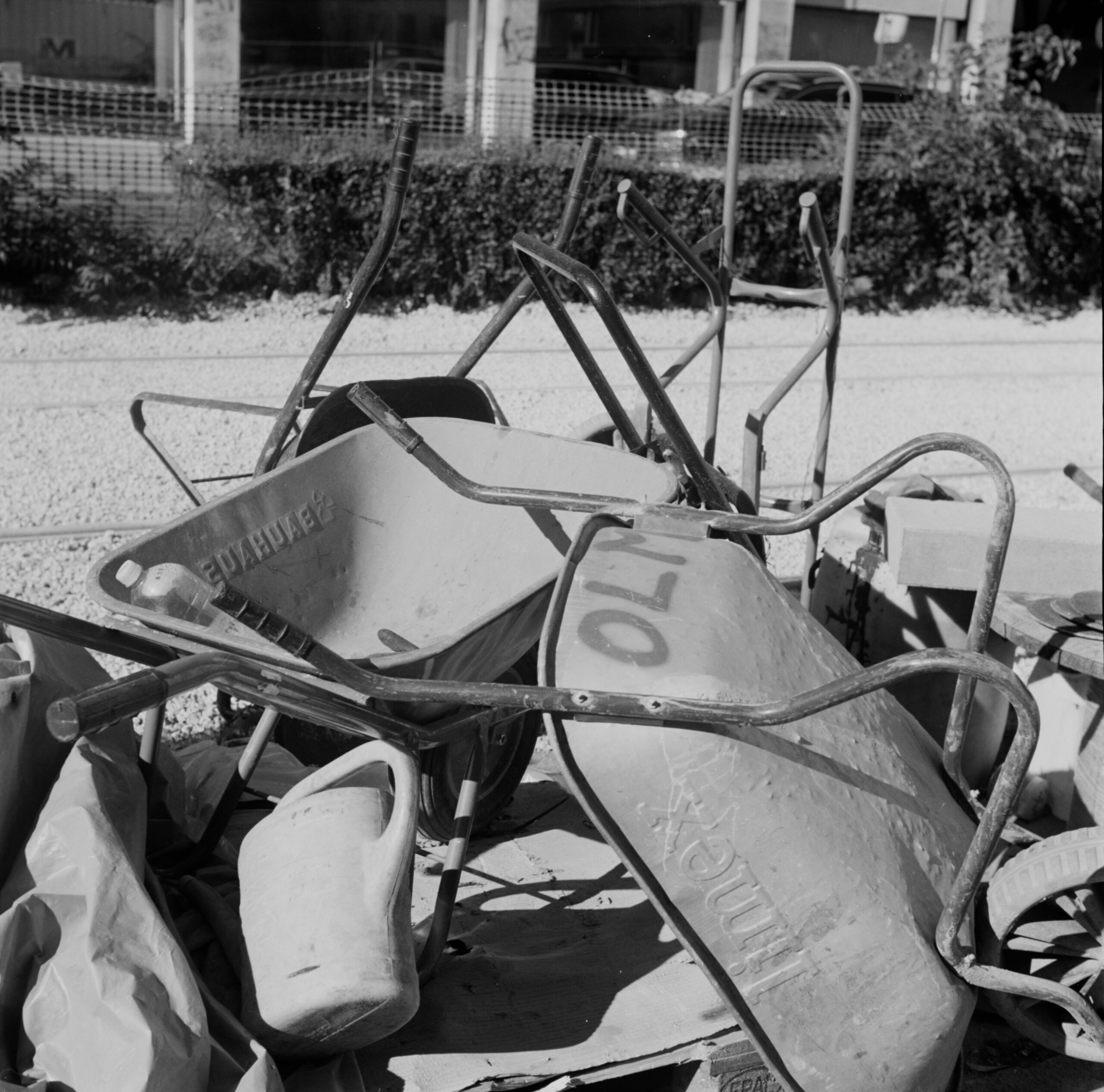 Black-and-white wheelbarrows and construction tools