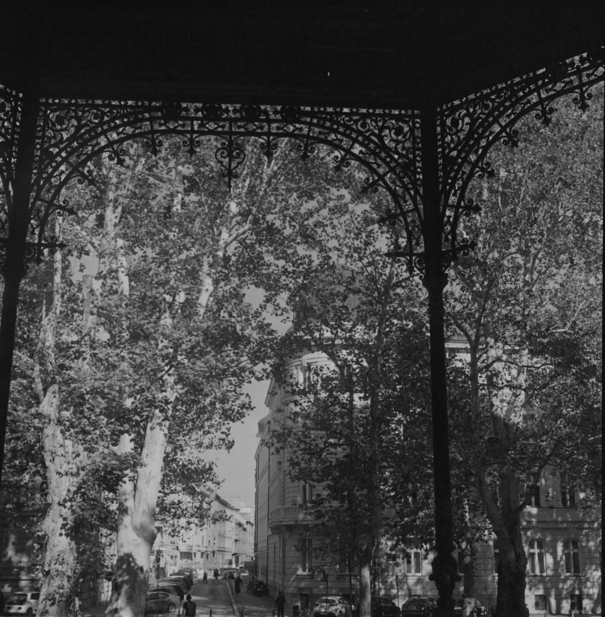 Black-and-white ornate arcade framing a Zagreb street