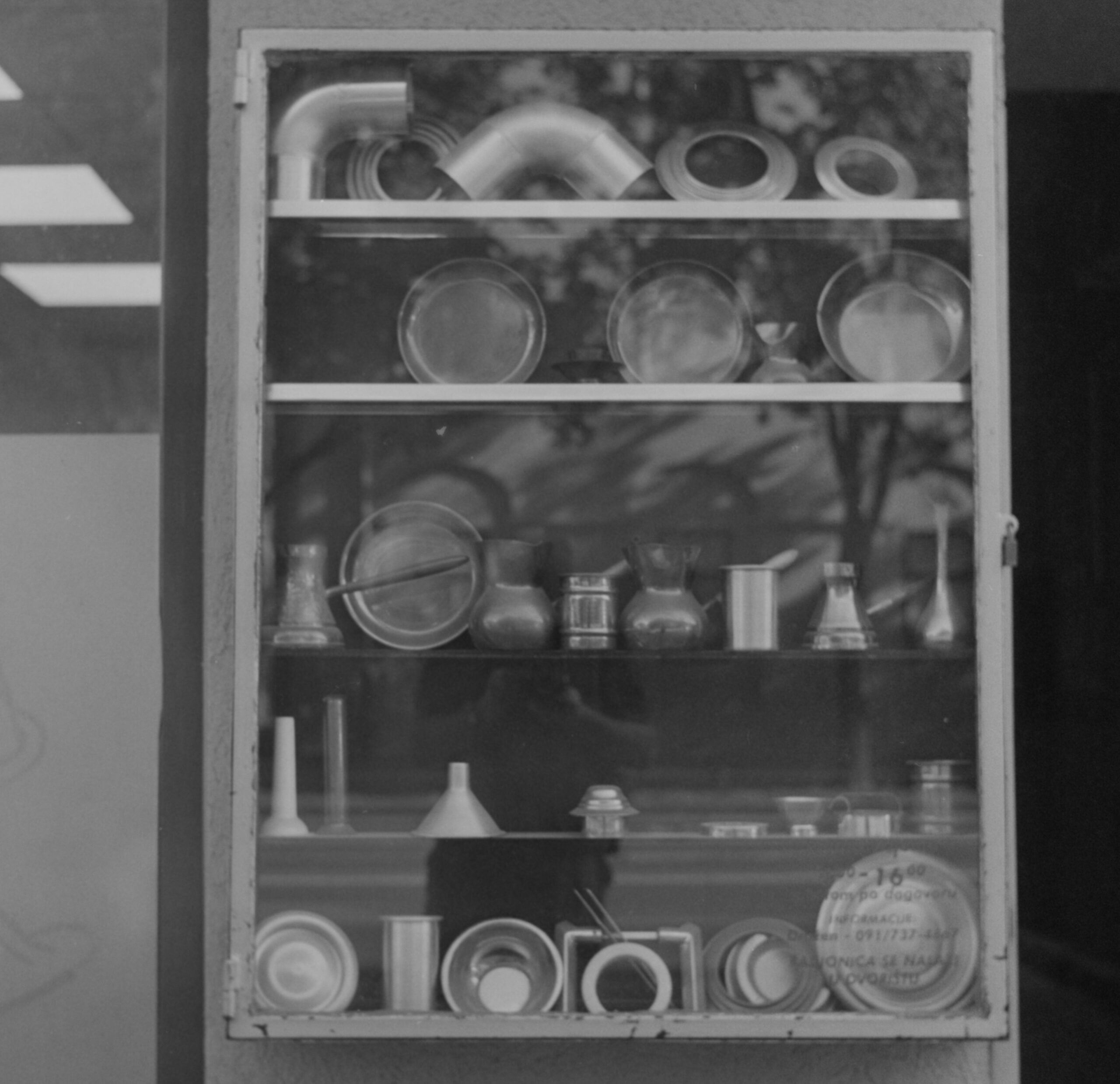 Black-and-white display cabinet with laboratory glassware