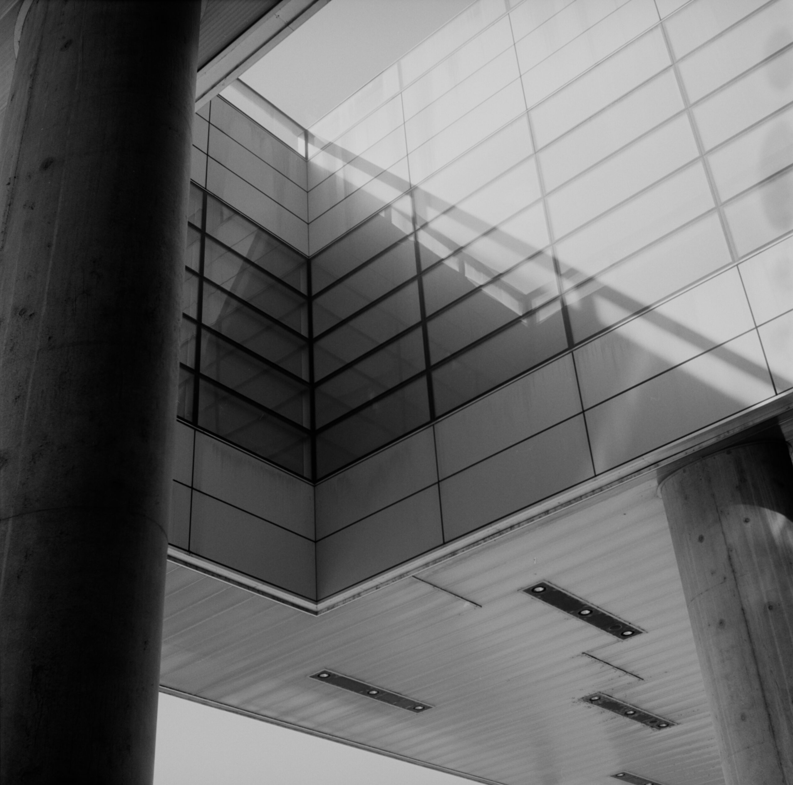 Black-and-white modern building interior with concrete and glass