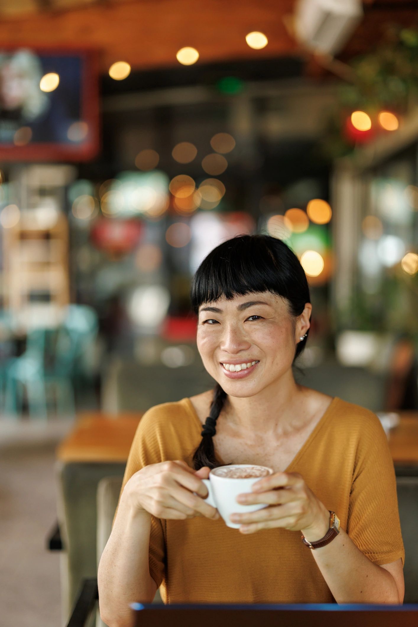 Woman working in a cozy café